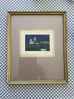 Framed etching of Venice, showing the full piece with frame and matting on a checkered cloth background.