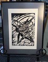 Full view of framed 'Spirit Dancer' etching on a stand showing the entire artwork and frame.