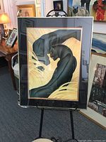 Full view of the large framed print showing two black panthers posed in golden grass with stylized shading, inside a gold aluminum frame with triple mats.