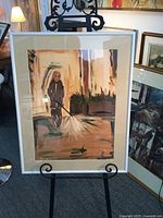 Framed impressionist painting showing full image of person power washing outdoors, in a white aluminum frame with matting.