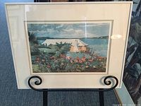 Full view of the framed fine print by Winslow Homer showing the flower garden, white bungalow, and ocean scenery.
