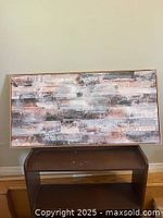 Front view of the framed abstract wall art showing layered brush strokes in earthy tones with a light wood frame.