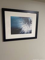 Front view of the framed abstract art print showing the artwork, the white mat and the black frame.