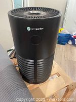 Front view showing GermGuardian logo and cylindrical black body with vertical vents.