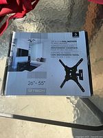 Front of the GTECH full motion TV wall mount box showing product image and size compatibility (26" to 55")