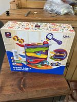 Front image of the new Hahaland Pound A Ball & Car Ramp boxed toy for children 12 months and older, showing colorful ramps, toys, and hammer.