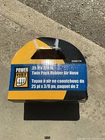 Product packaging showing Power Fist branding and key specifications of twin pack rubber air hoses.