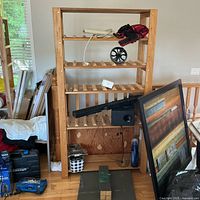 Front view of the wooden wine rack shelving unit showing multiple shelves with slots for wine bottles. Surrounding items not included.