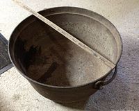 Overview of cauldron with measuring stick across rim