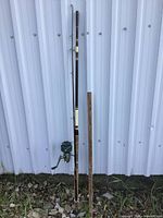 Full view of the heavy duty fishing pole with attached reel, showing the length and condition of the pole and reel.