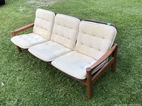 Front left three-quarter view of entire sofa on grass