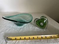 Photo showing the two glass pieces side by side with tape measure for scale, approximately 10 inches long bowl and smaller heart vase