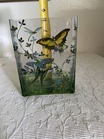 Front view of the clear glass Fringe Studio vase with yellow butterfly, dragonflies, bird, and floral designs.