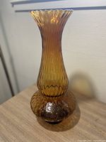 Full view of the vintage amber Empoli vase with optic pattern showing flared, ridged neck and rounded base