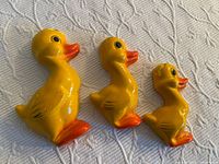 Frontal photo of the three vintage chalk ware duck figurines showing size difference and details
