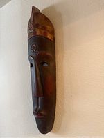 Full view of African wooden mask showing overall design and shape