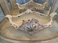 Front view of the large ceramic bowl with ornate floral design, scrollwork, and cut-out details.