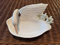 Top angle of white ceramic swan dish showing wing and starfish detail