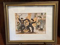 Framed art piece featuring dancing Jewish men in traditional attire, outdoor setting with stone ruins, signed by artist