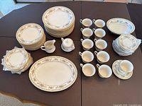 Full view of the china set arranged on table showing plates, cups, saucers, and serving pieces
