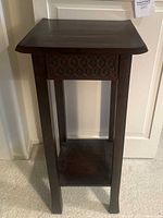 Side angle view showing curved top edges and wood finish.