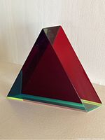 Front view of the acrylic triangular prism showing red and green color layering
