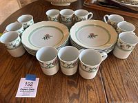 Overall set of 12 coffee cups and 12 dessert plates arranged on table