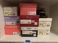 Stack of multiple original shoe boxes from Munro, Naturalizer, and Easy Spirit showing labels with sizes and model names