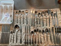 Full assortment of flatware laid out with plastic tray