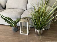 Overview of both faux plants and lantern