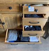 Four open dresser drawers showing multiple folded women’s garments