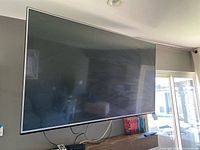 Front view of LG 65-inch TV powered on mount