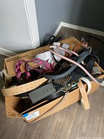Box containing many assorted belts