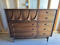 Front view showing drawers, doors, pulls and base