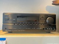 Front view showing model, controls, HDMI logo