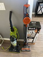 Shark Rocket stick vacuum and Eureka AirSpeed upright side by side