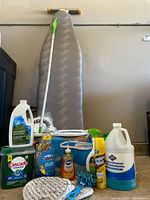 Group shot of ironing board and all cleaning items