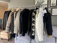 Rack of assorted jackets and sweaters on hangers