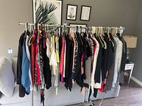 Full rack of assorted tops on hangers