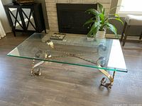 Full view of coffee table showing glass top and iron base
