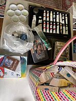Photo of assorted paint tubes mostly from Winsor & Newton and Stevenson in a box and plastic bag, showing different colors and used condition.