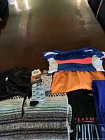 Top view photo of assorted vintage clothing and blanket laid out on the table