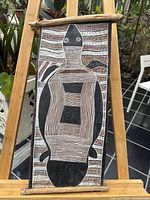 Full view of the bark painting showing the entire fish design and wooden frame.