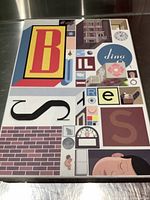 Complete view of the Building Stories box set cover with colorful artwork and abstract letter and shape collage.