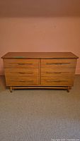 Front view of mid-century modern six-drawer wood dresser
