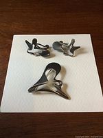 Brooch and earrings laid flat on white background