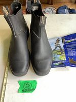 Front view of the black leather Blundstone Chelsea boots showing elastic side panels and pull tabs with branding.