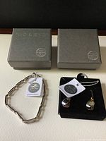 Bracelet and earrings set with original NIC & SYD boxes and Swarovski crystal tags visible