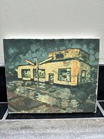 Front view of the acrylic painting showing the building and rainy night scene.