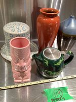 Full view of all 5 ceramic pieces on metal surface showing scale with measuring tape.